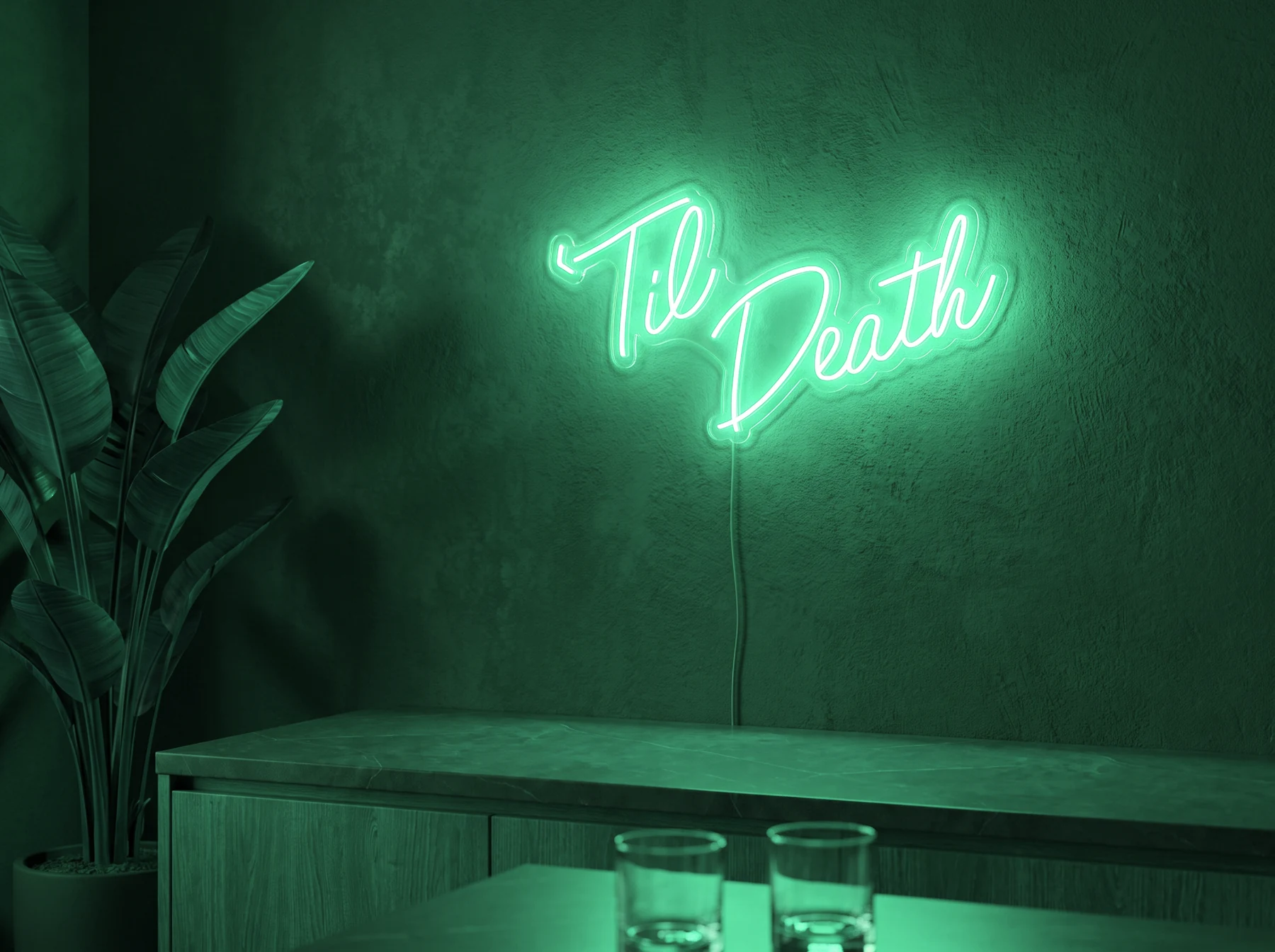 Neonskylt «Til Death» i mintgrön LED-neon, monterad på vägg