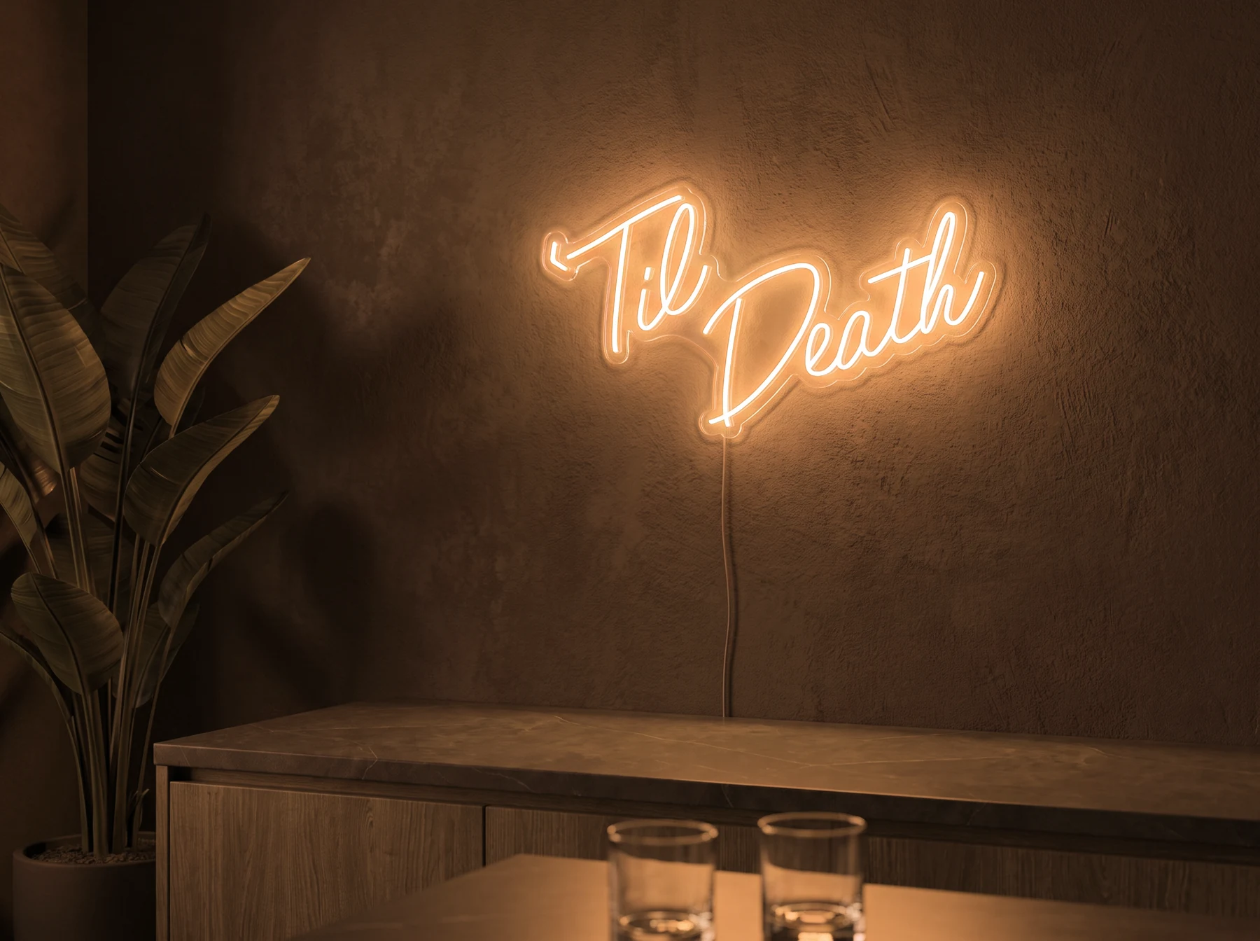 Neonskylt «Til Death» i orange LED-neon, monterad på vägg