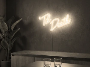 Neonskylt «Til Death» i varmvit LED-neon, monterad på vägg