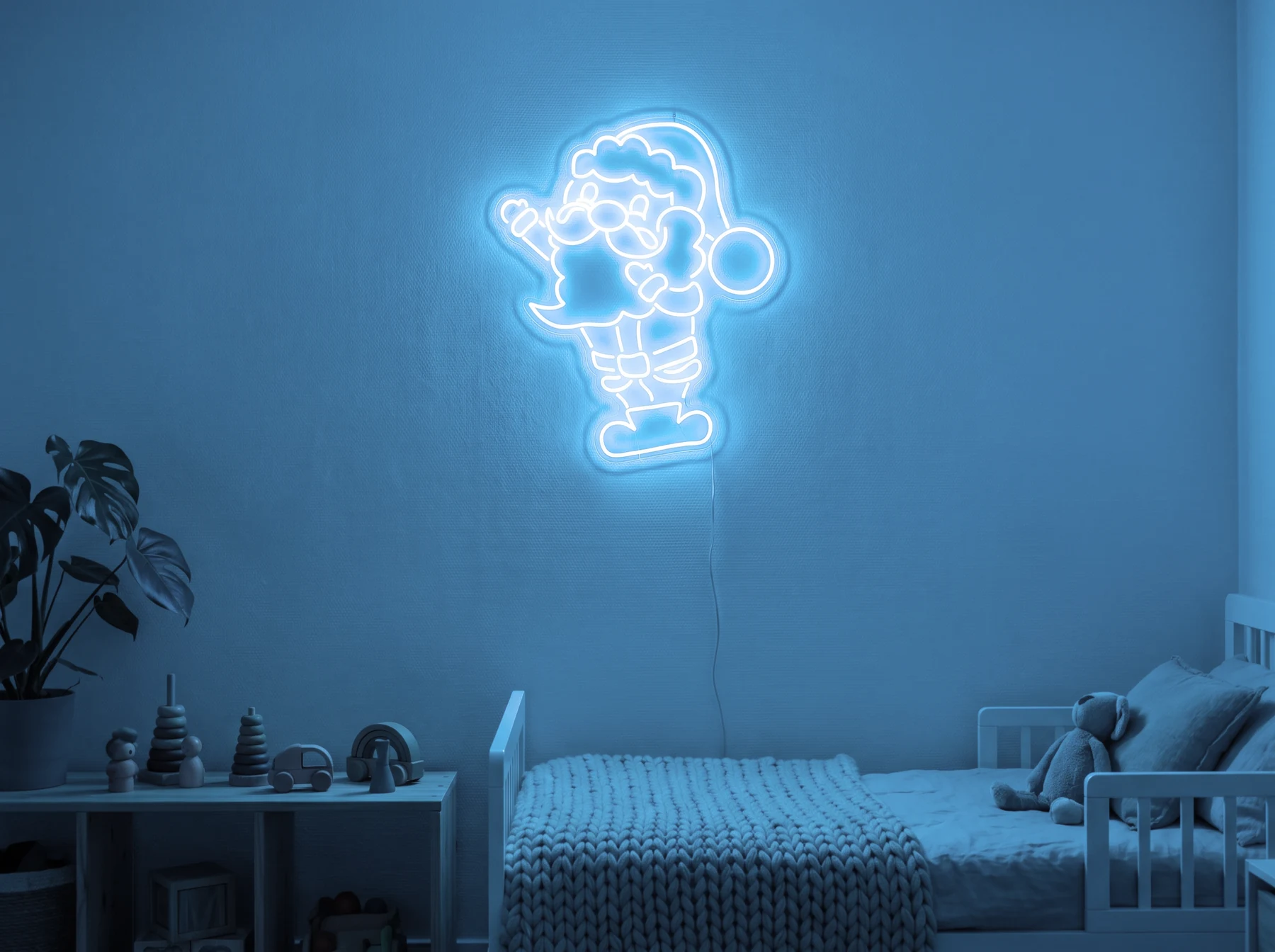 Neonskylt «Tomten» i isblå LED-neon, monterad på vägg