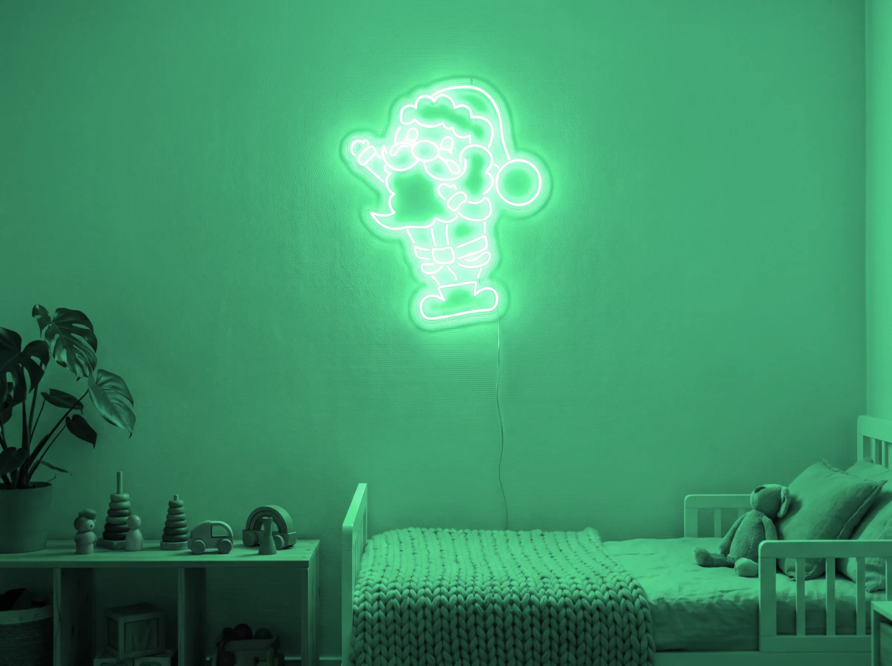 Neonskylt «Tomten» i mintgrön LED-neon, monterad på vägg