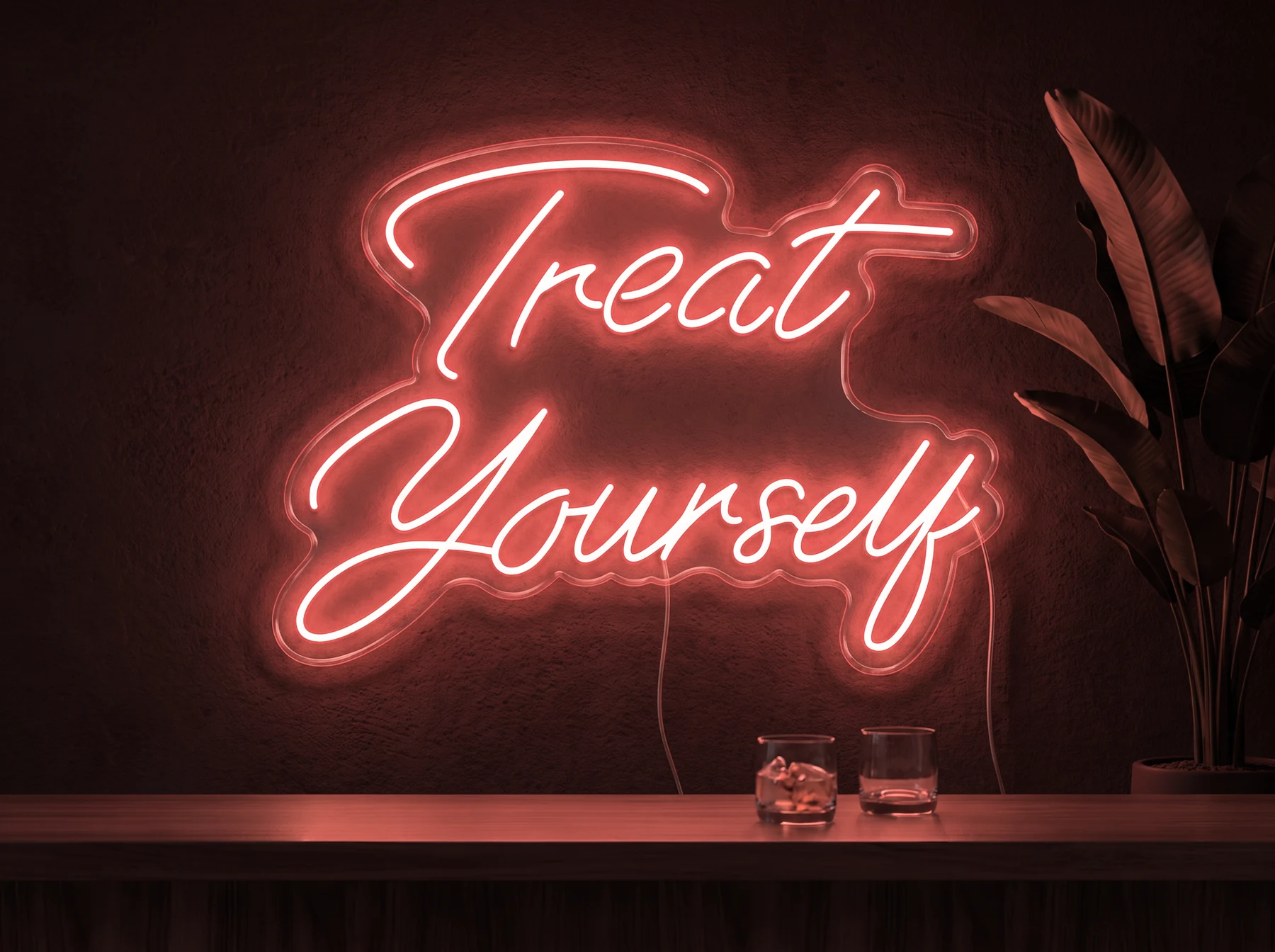 Neonskylt «Treat Yourself» i röd LED-neon, monterad på vägg