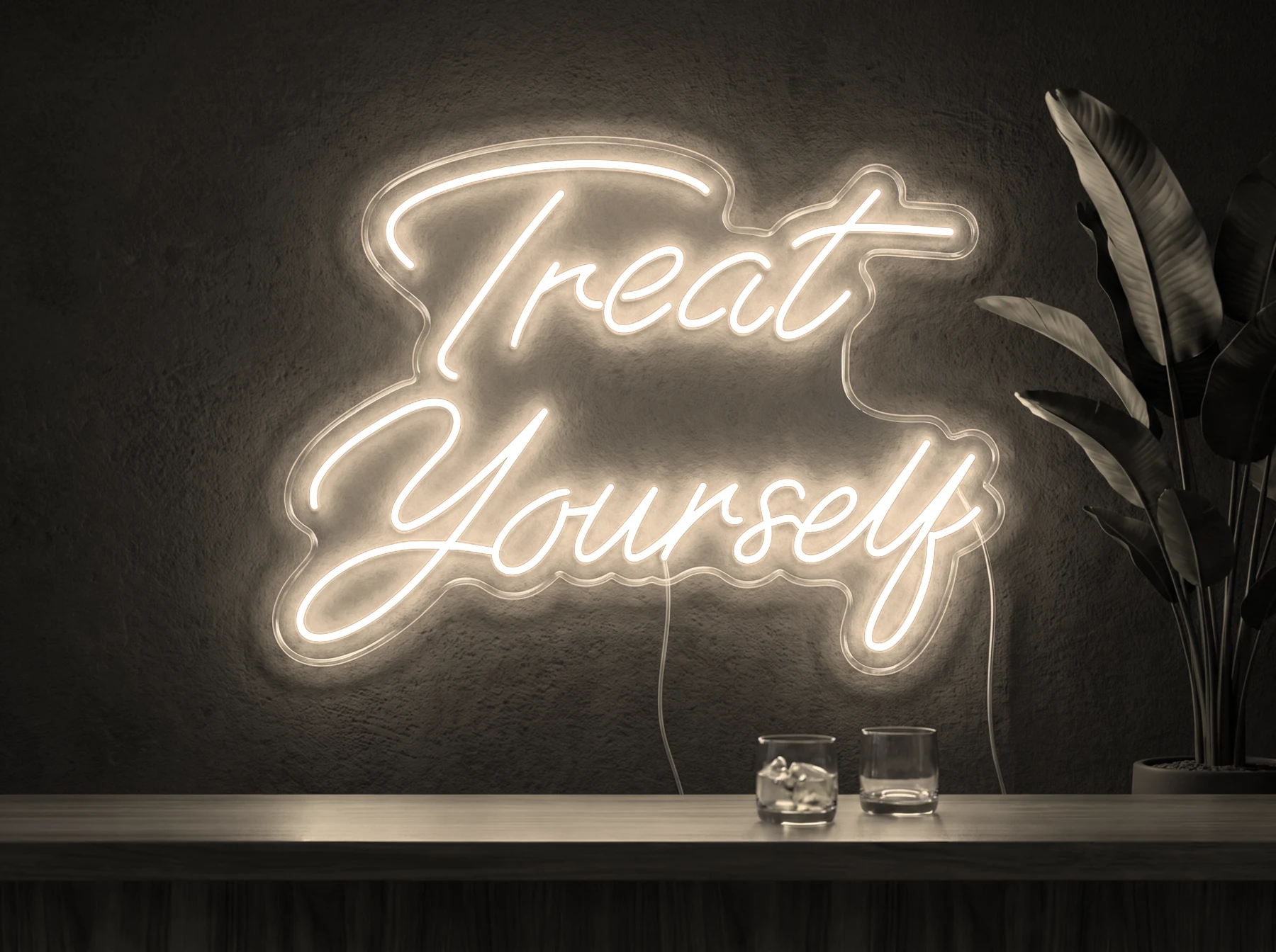 Neonskylt «Treat Yourself» i varmvit LED-neon, monterad på vägg