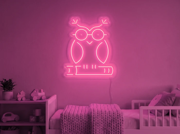 Neonskylt «Uggla» i rosa LED-neon, monterad på vägg