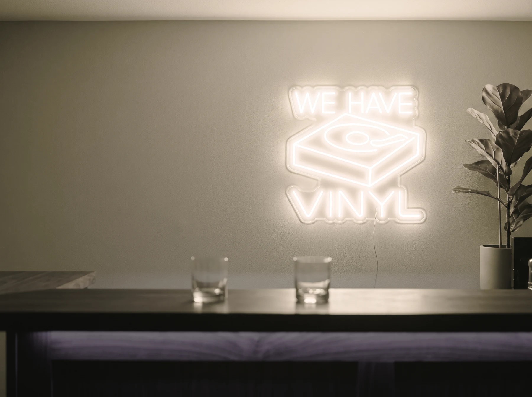 Neonskylt «We Have Vinyl» i varmvit LED-neon, monterad på vägg