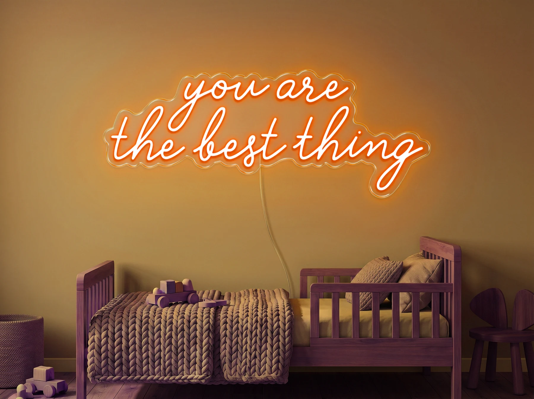 Neonskylt «You Are The Best Thing» i orange LED-neon, monterad på vägg