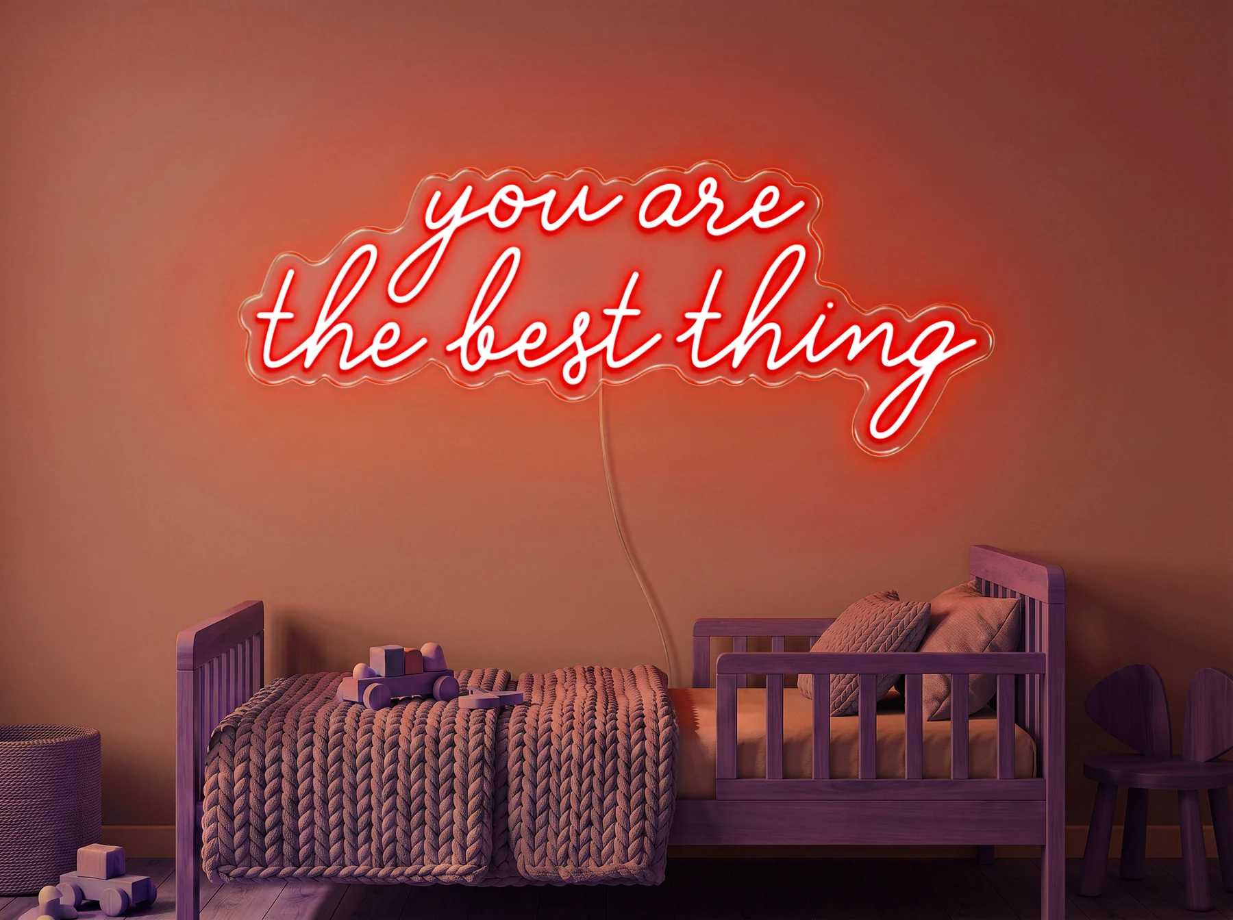 Neonskylt «You Are The Best Thing» i röd LED-neon, monterad på vägg