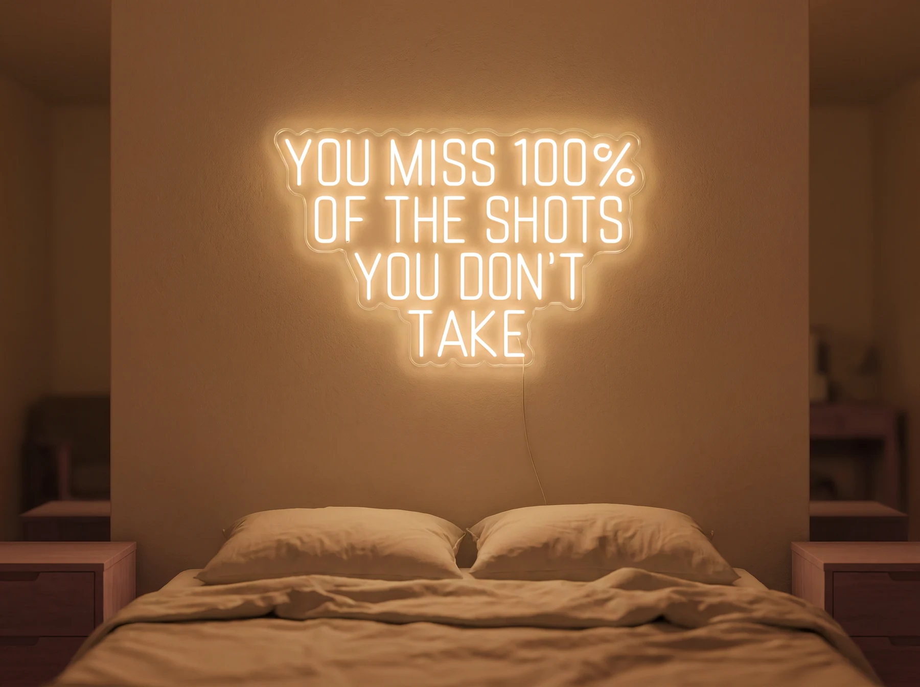 Neonskylt «You Miss 100% Of The Shots» i orange LED-neon, monterad på vägg