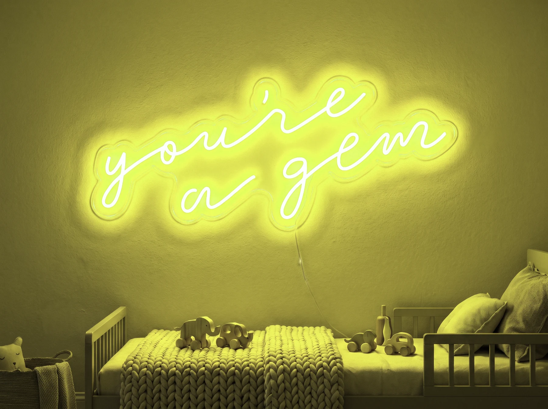 Neonskylt «You’re A Gem» i gul LED-neon, monterad på vägg