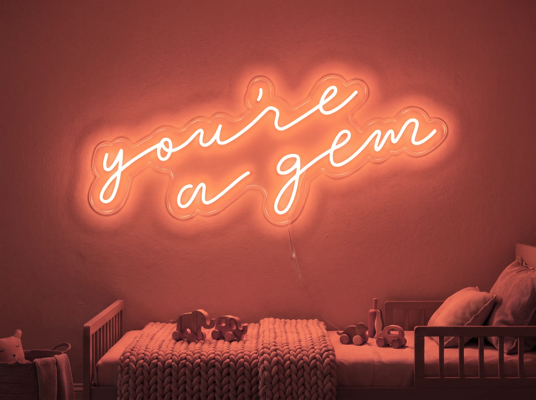 Neonskylt «You’re A Gem» i röd LED-neon, monterad på vägg